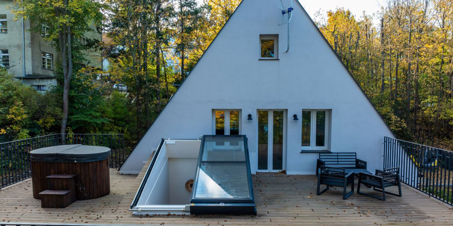 house in background with terrace and roof access rooflight leading to terrace
