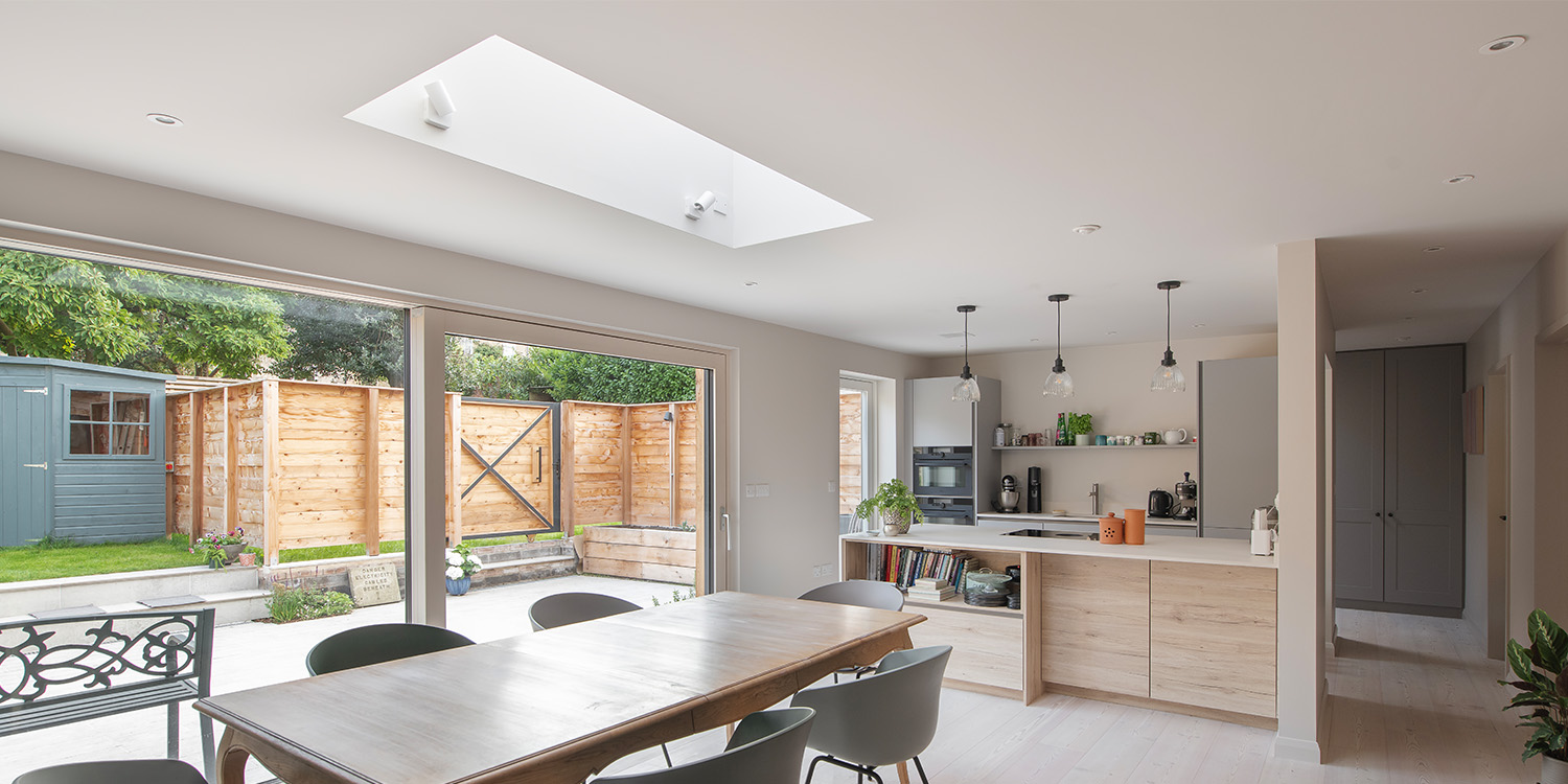 Kitchen extension lit by a long skylight