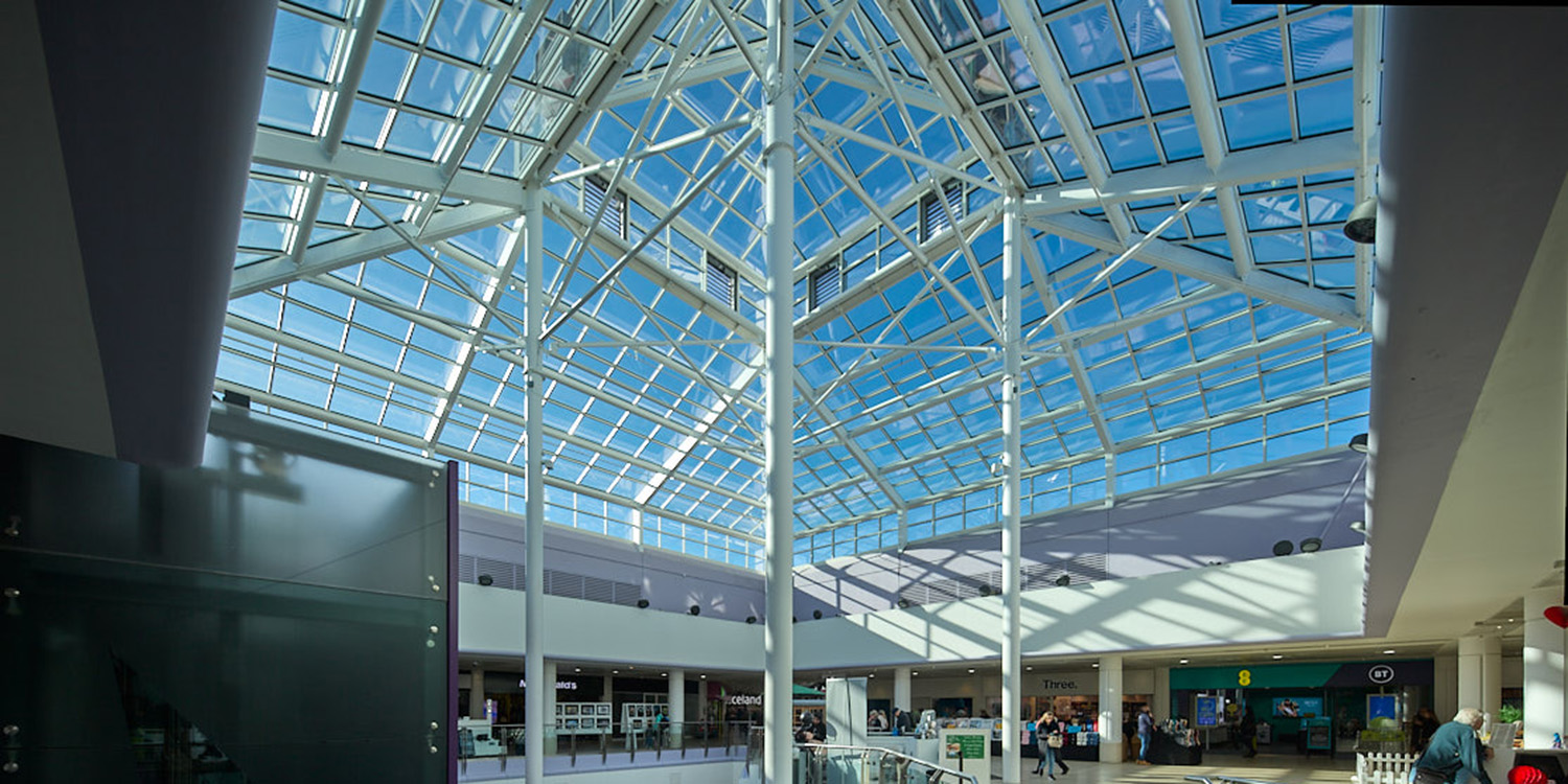 internal view of shopping centre with large glass roof