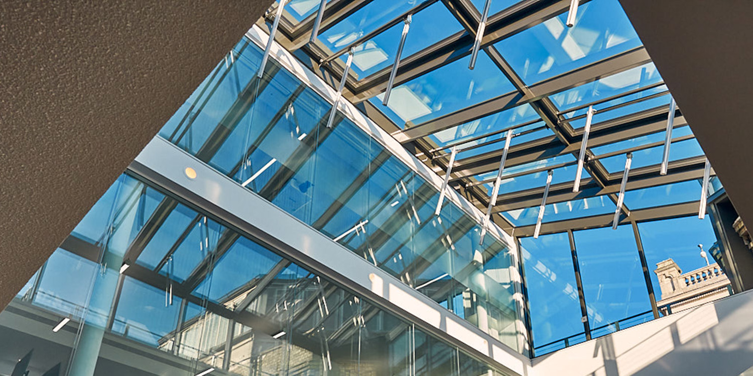 Large glass roof with reflection of glazing