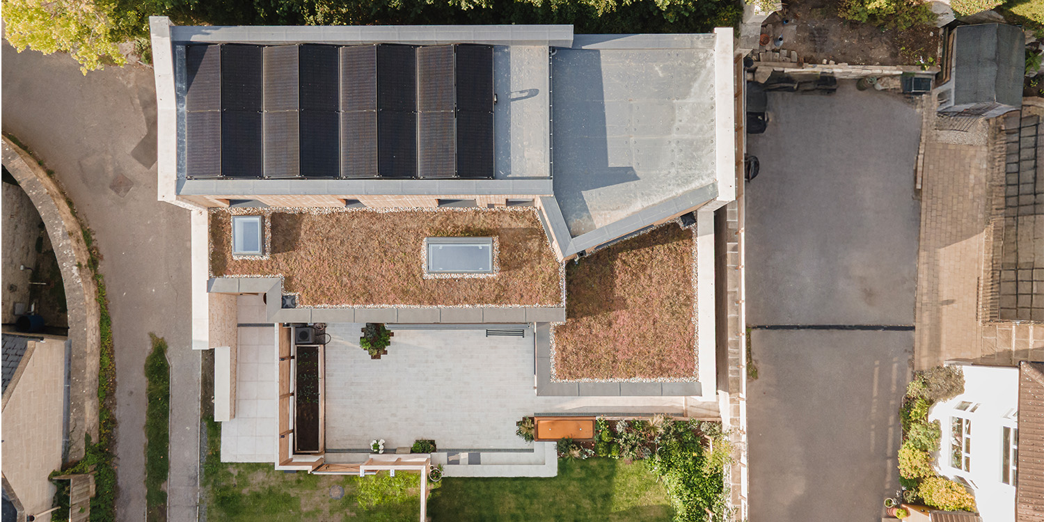 Birds eye view of house with solar panels and rooflights on roof